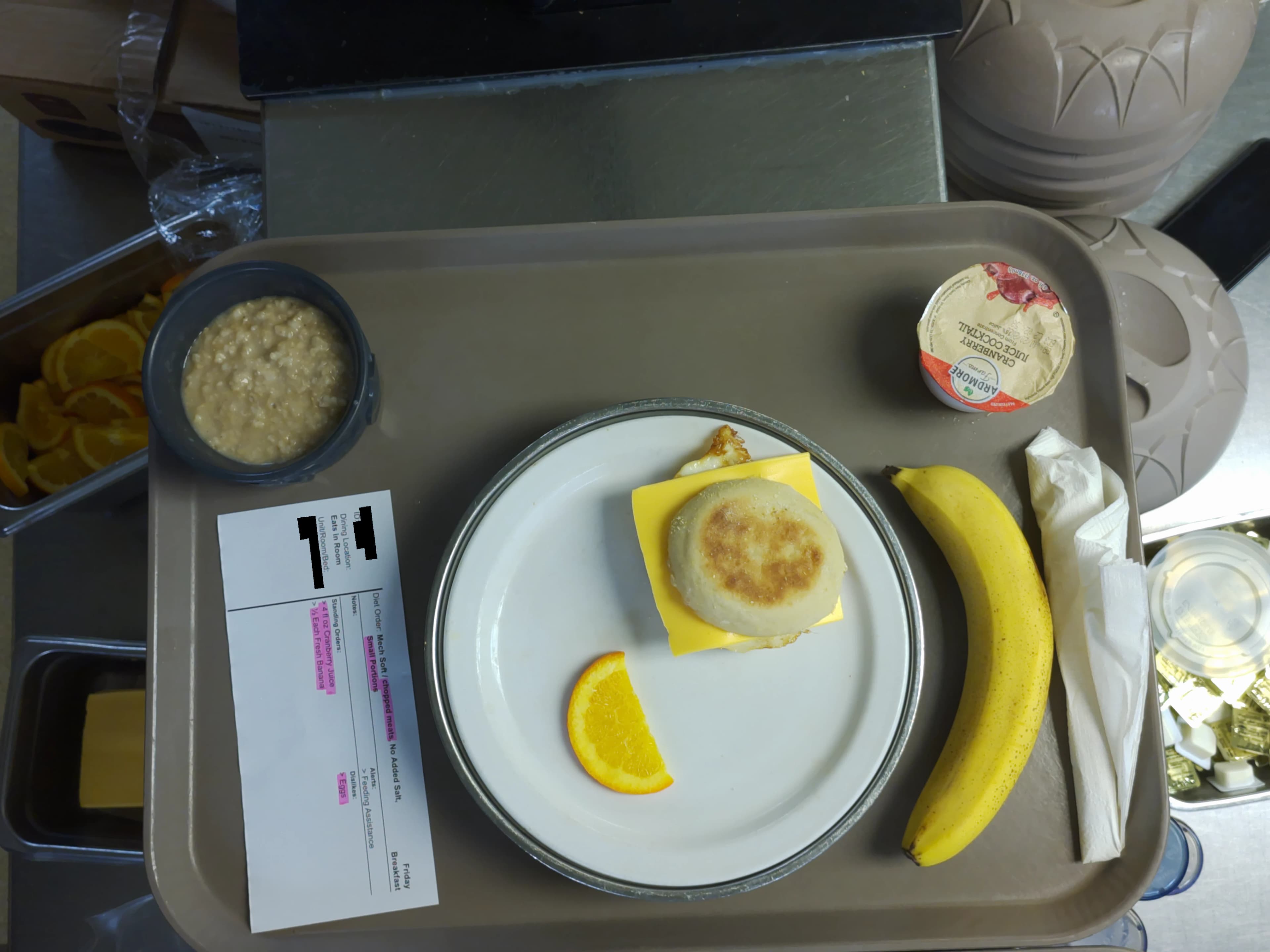 Tray photo: modified-texture ticket, an intact English-muffin sandwich, and a whole banana.